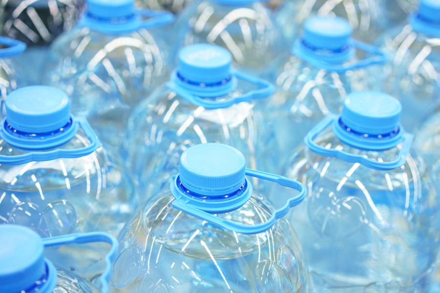 Primer plano de botellas de agua potable de plástico de cinco litros.